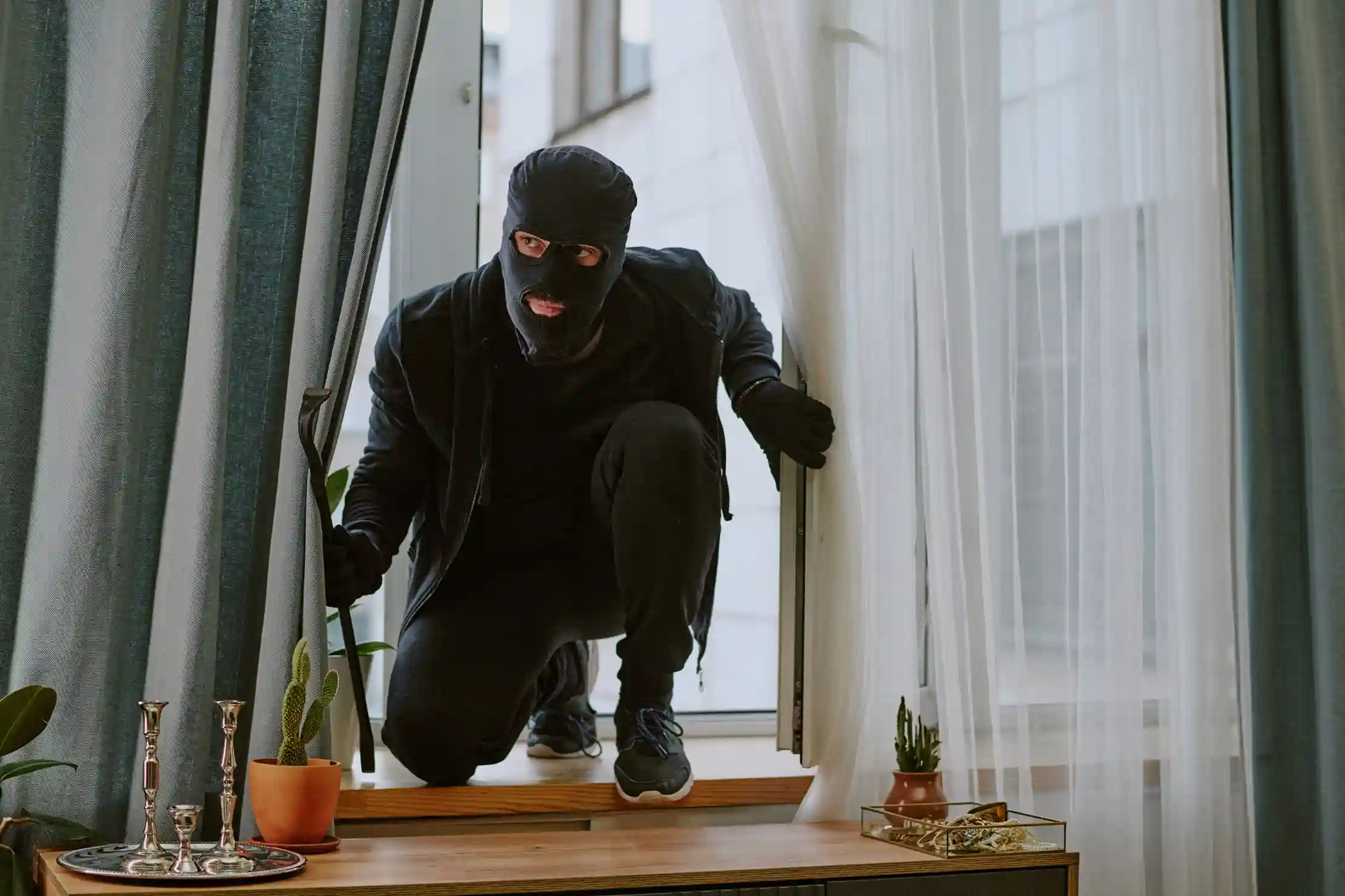 Intruder climbing through a window in disguise.