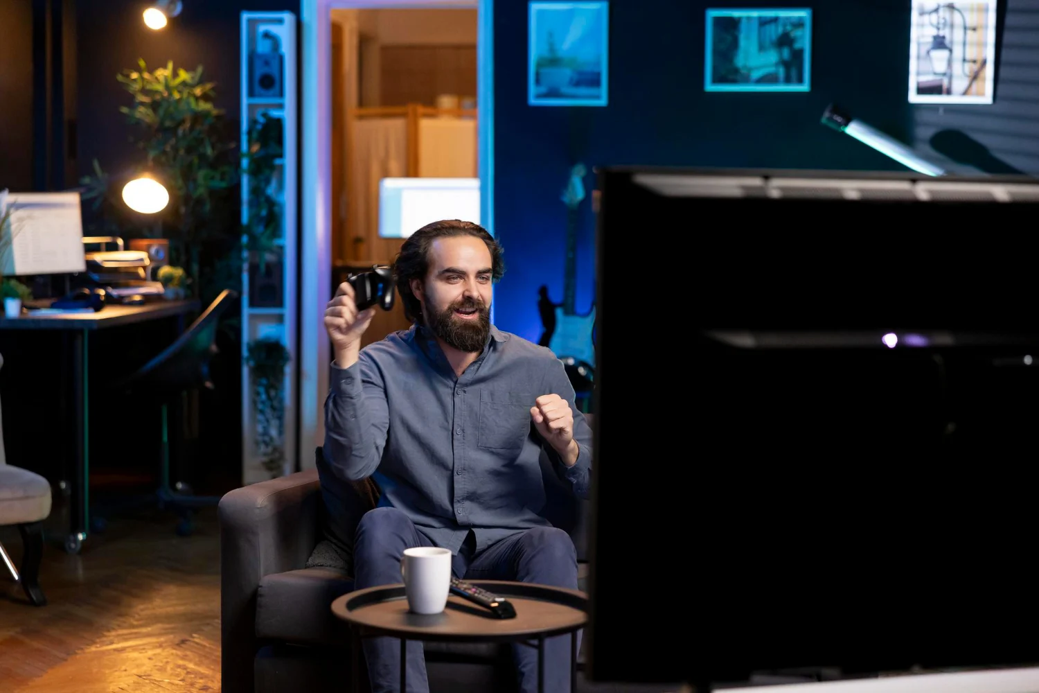 Man joyfully gaming in a cozy living room.