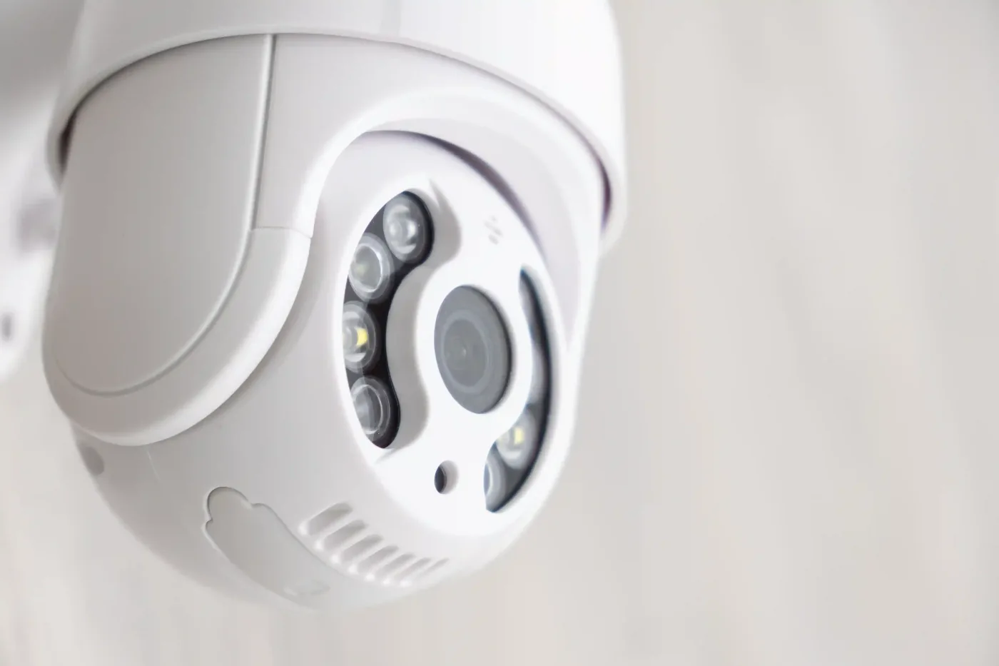 Close-up of a white security camera.