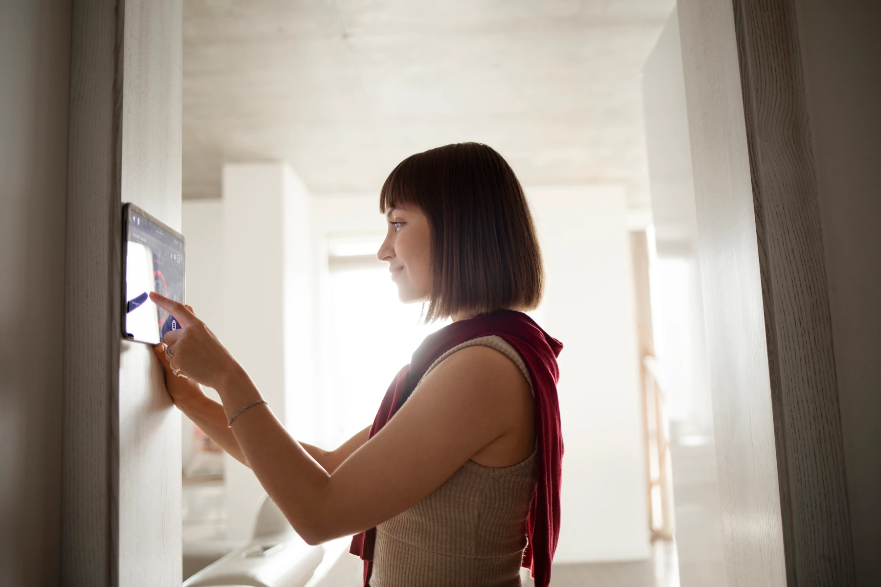 Person interacting with a touchscreen device indoors.