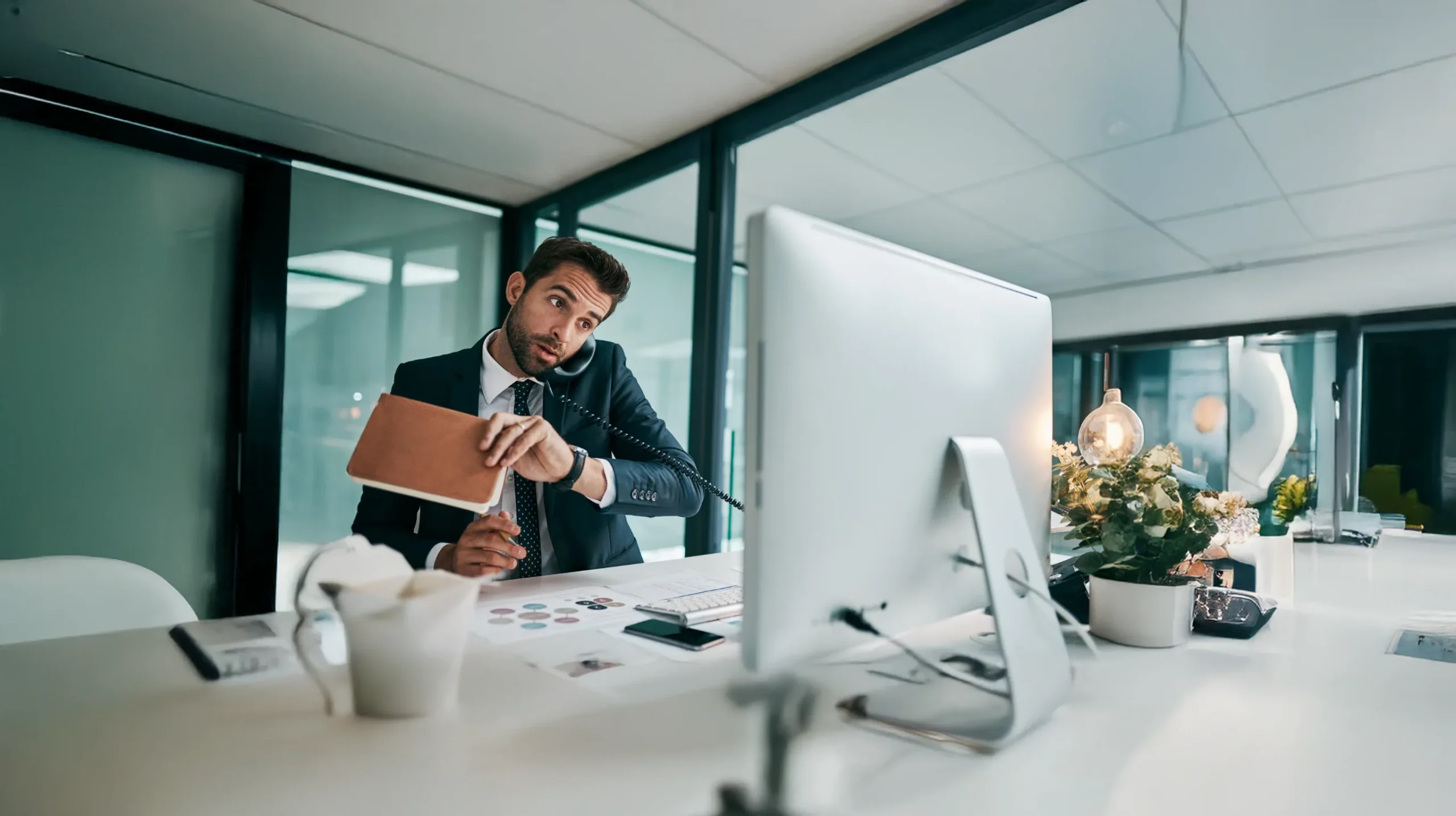 Businessman multitasking in modern office environment.