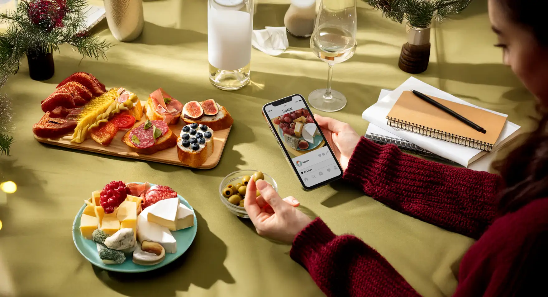 Person enjoying gourmet food and using smartphone.