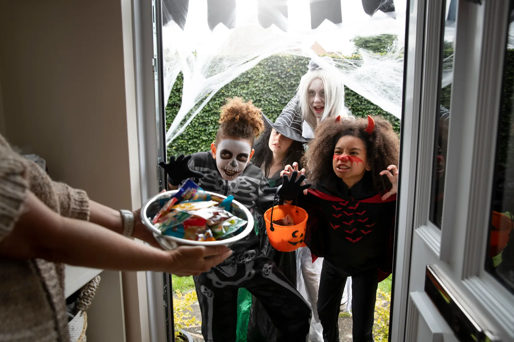 Children in costumes excited for Halloween treats.