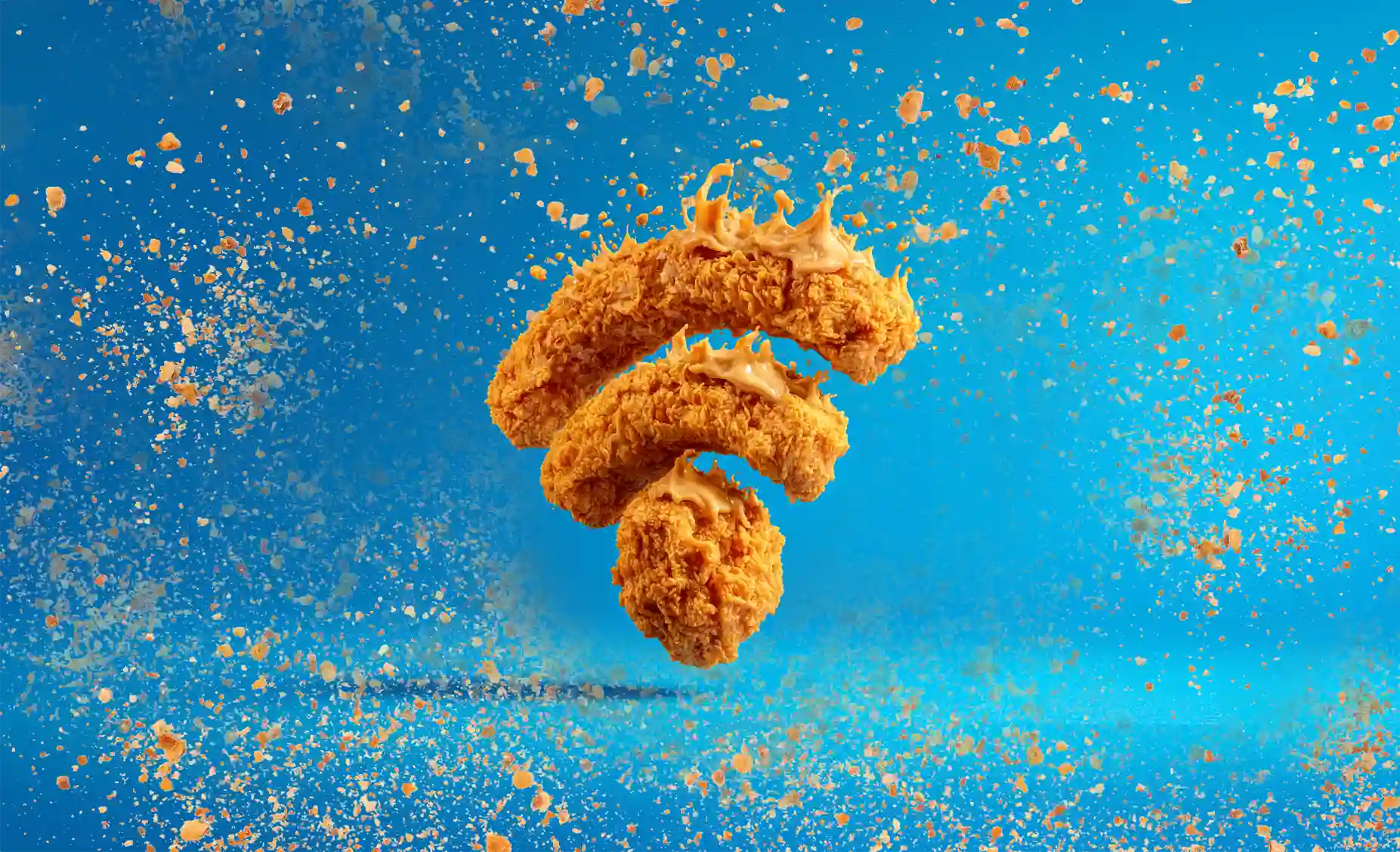 Crispy chicken pieces with vibrant blue background.